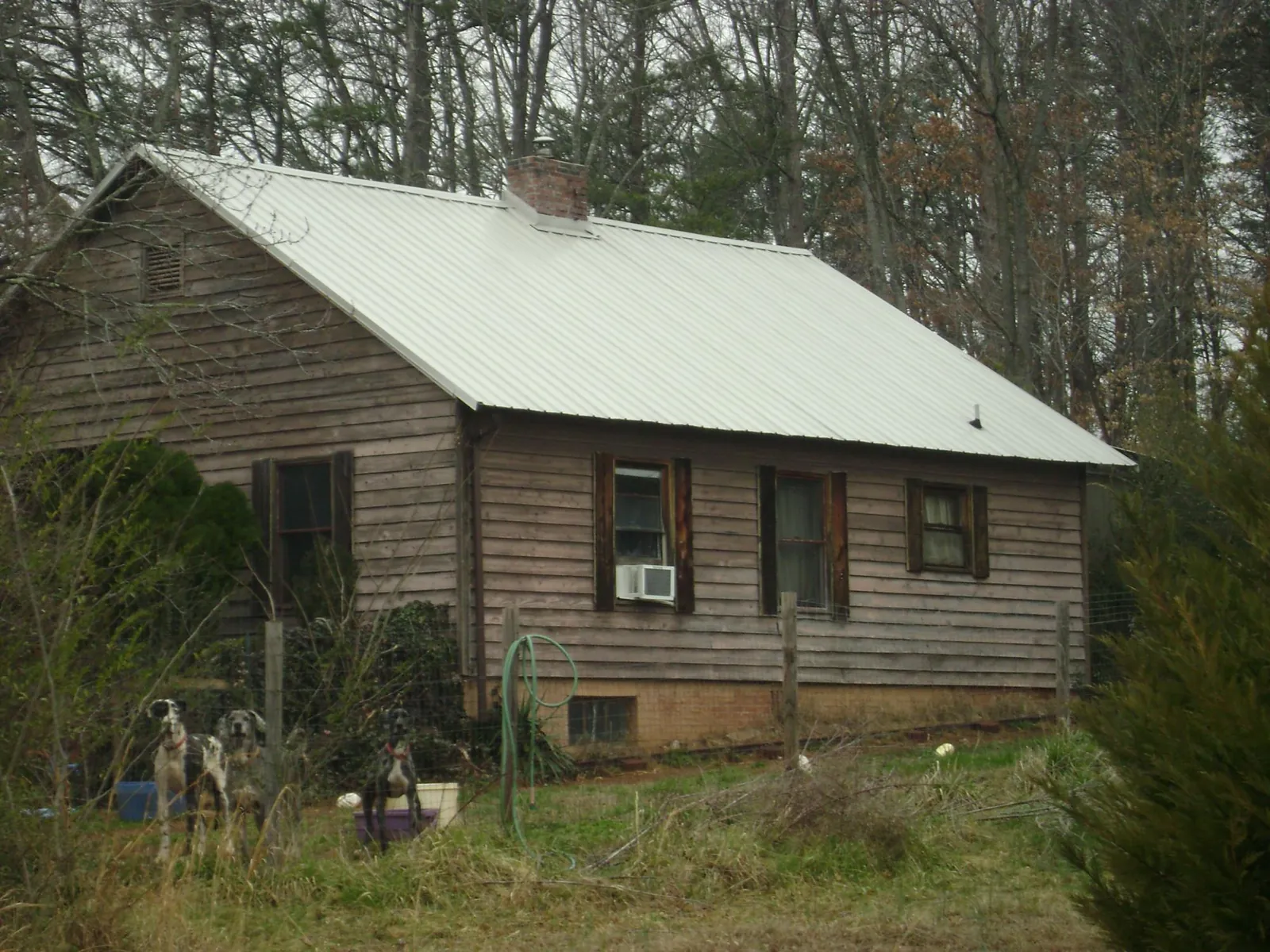 White metal roof on an old wood sided farmhouse, from a Metal Roof Installation job in Lincolnton